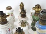 many different types of oil lamps on the table