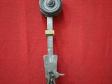 a metal tool with a handle on a red surface