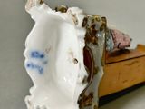 a small figurine of a woman laying on a bed
