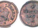a close up of a coin with a bell on it