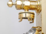 a brass faucet that is attached to a wall