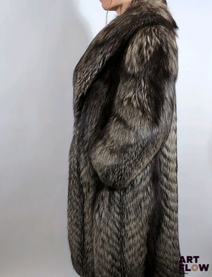 a woman in a fur coat is standing in front of a white background