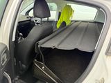 a car with the back seat folded open with a bag in the trunk