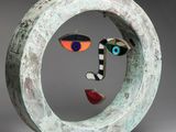 an image of a sculpture of a face in a circle