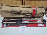 two red and black tools sitting on top of a white table