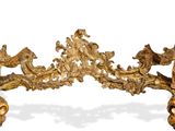 a gold colored bench with ornate carvings on it