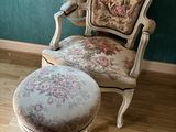un fauteuil et un pouf dans un coin de la pièce