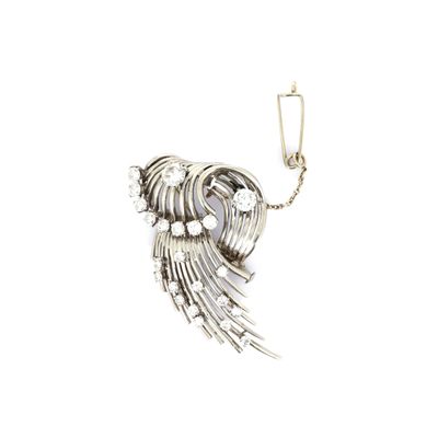 silver plated broochle with wings and pearls on a white background