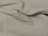 a close up picture of a bed with a white sheet on it