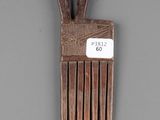 a small wooden comb with a tag on it