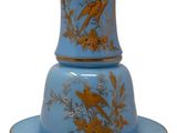 a blue and gold plate with a bird on it