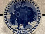 a blue and white plate with a picture of a man on a horse