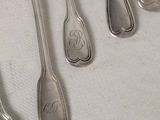 several spoons and spoon spoons are lined up on a table