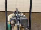 an image of a small engine on a cart in a garage