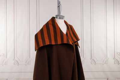an orange and brown striped cape on a mannequin mannequin mannequin mannequin mannequin mannequin mannequin mannequin