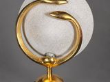 an image of a gold and white marble sculpture on a stand