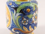 a blue and yellow vase with a design on it