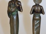 two statues of a woman and a man standing next to each other