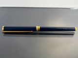 the pen is sitting on the table next to it ' s cap