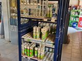 many cans of paint on the shelves in the store