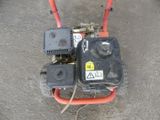 a small lawn mower that is sitting on the ground