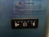 a sign on the side of a machine that says caution