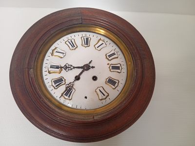une horloge accrochée au mur et comportant des chiffres romains