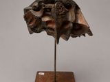 an image of a sculpture of a shell on a wooden base