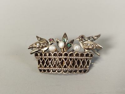 a close up of a broochee with birds on it