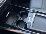 a cup holder in the center of a car ' s center console