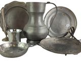 a lot of silver items that are sitting on a table