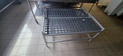 tiled floor in a restaurant kitchen with a stainless steel table and chairs