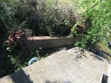 a rusted out train car sitting on the side of the road