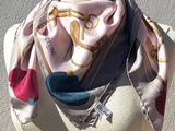 pink and blue scarf on mannequin torso with white background