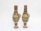 two vases that are sitting next to each other on a table