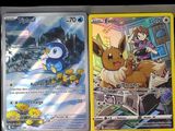 two pokemon cards are sitting next to each other on a table