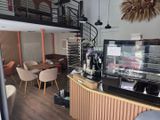un café avec un escalier menant au deuxième étage