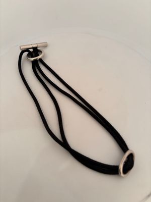a black cord with a silver clasp on it