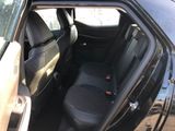 the back seat of a car with the door open and the passenger seat down