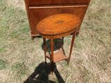 a small table with a wooden top in the grass