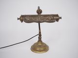 an old fashioned brass phone on a stand with a cord