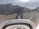 a reflection of a man on the side of a car