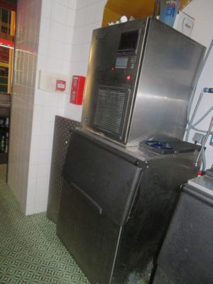 a kitchen with a refrigerator, stove, and sink