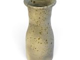 a small vase that is sitting on a white surface