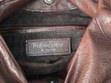 the inside of a brown leather jacket with a name tag on it