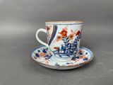 a blue and white cup and saucer on a saucer