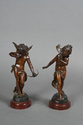 pair of antique bronze figurines of cupid and cupid holding a bow