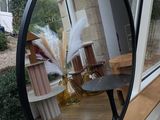 a mirror that is sitting on a window sill