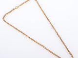 a gold chain necklace with a heart pendant on a white background