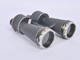 pair of black binoculars on white surface with white background